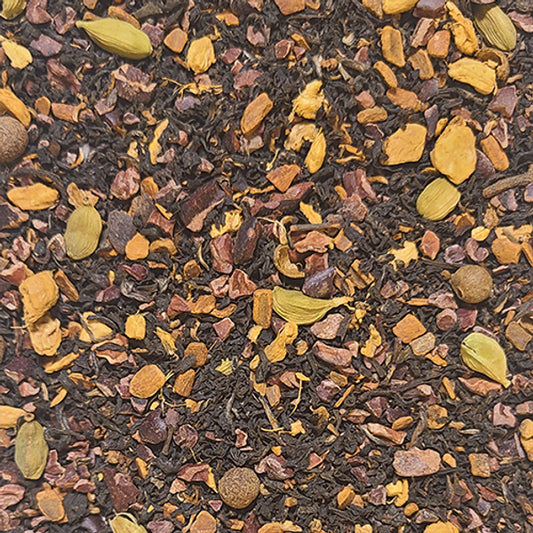 A close up of the Comfort tea blend - various chai spices and cacao nibs on a bed of black tea leaves