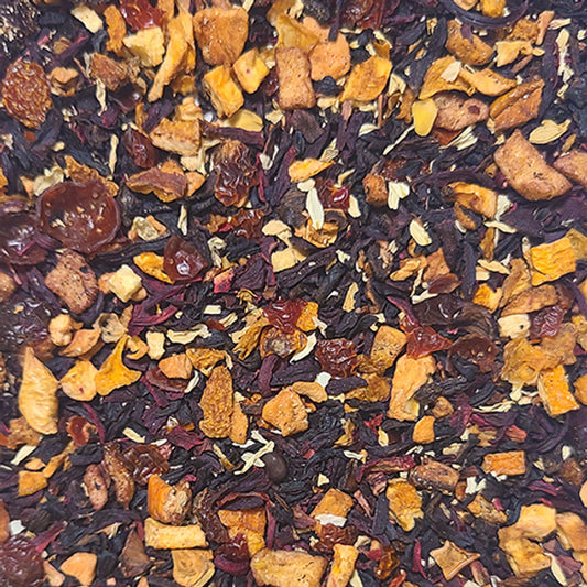 A close up of the Community tea blend - a mixture of dried fruit pieces and hibiscus petals